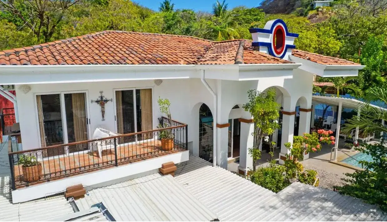 Exuding timeless Mediterranean elegance, the striking white façade features graceful archways and a private upper-level balcony.